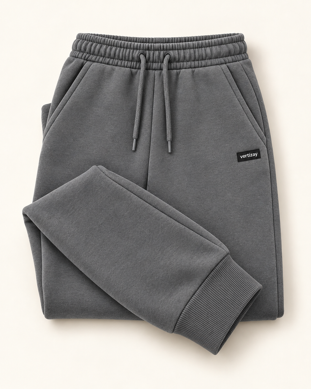 Folded slate Drift joggers showing waistband, drawstring and vertizay label.