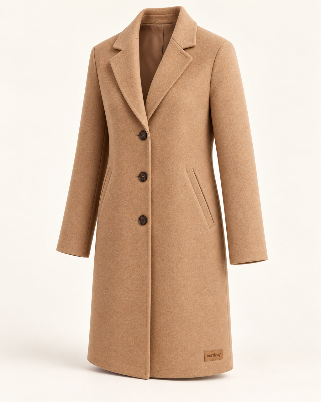 Three-quarter view of the camel Solstice coat showing its straight silhouette and welt pockets.