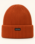 Rust Summit rib-knit beanie with folded cuff and centered vertizay label, front view.
