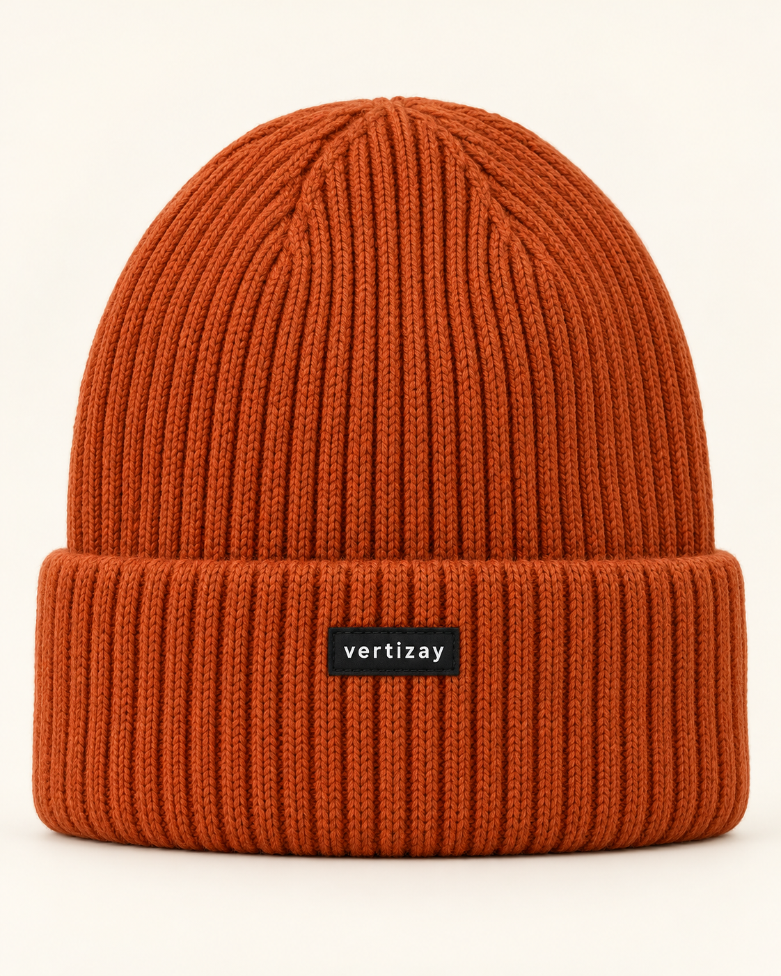 Rust Summit rib-knit beanie with folded cuff and centered vertizay label, front view.